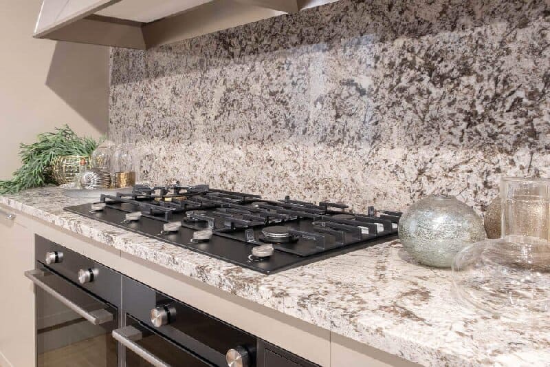 Modern kitchen with granite island and marble backsplash